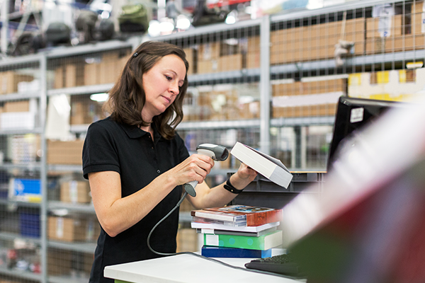 A librarian scanning a book